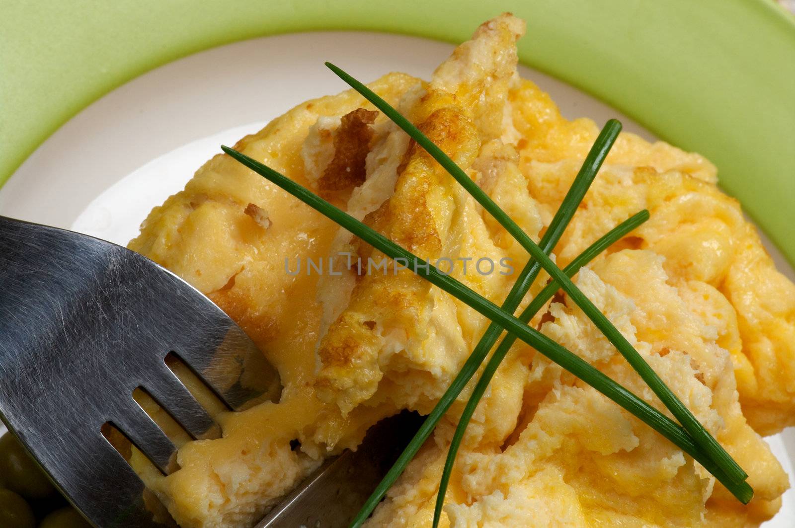 Omelet with Onion and Fork on Green Plate close up 