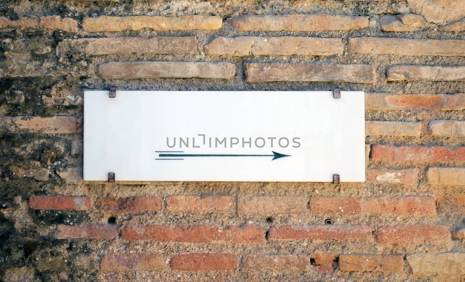 Empty white stone sign on old wall