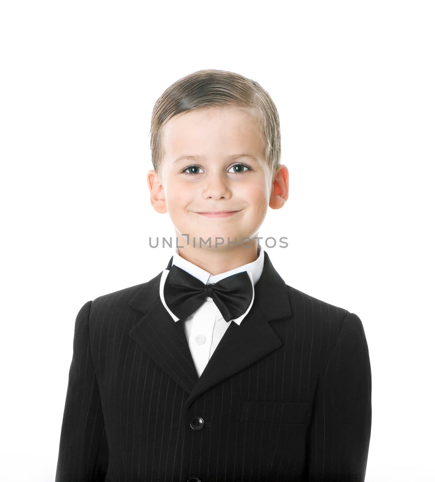 Boy in a suit smiles isolated on white background