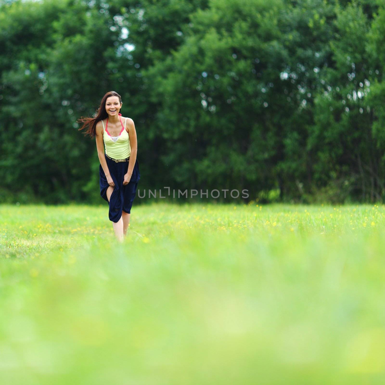 woman on green grass field by Yellowj