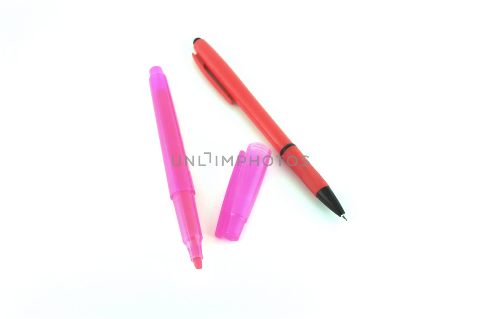 Red pen and pink felt-tip pen over white