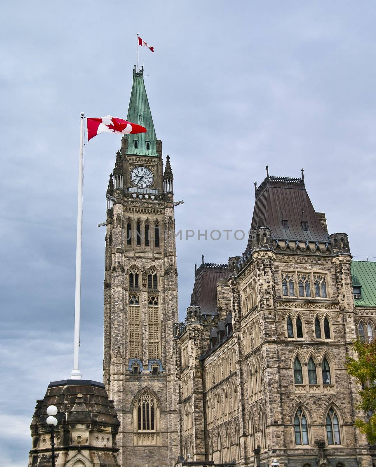 The canadian Parliament Centre Block building with canada flags in Ottawa.