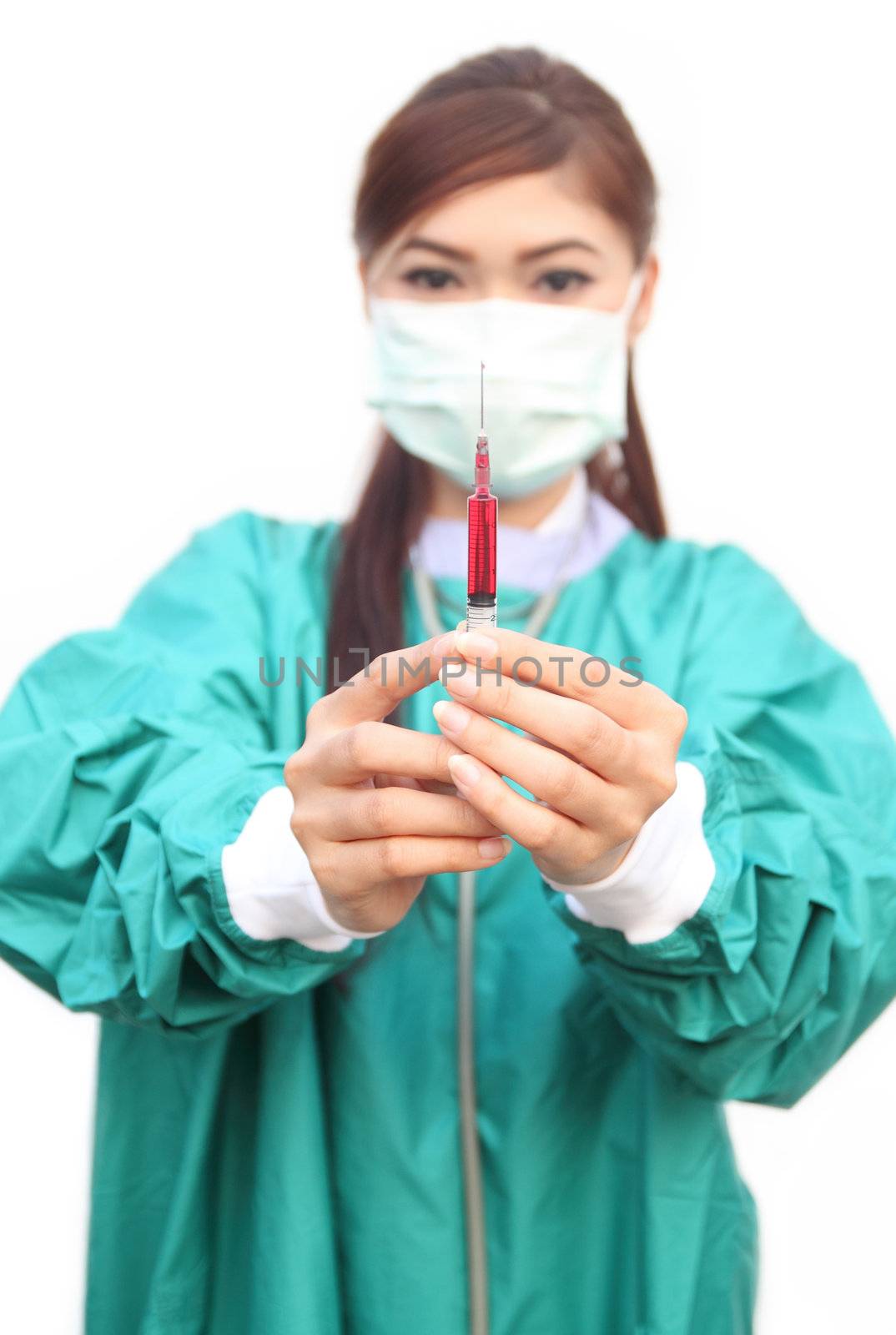 female doctor wearing a green scrubs with syringe