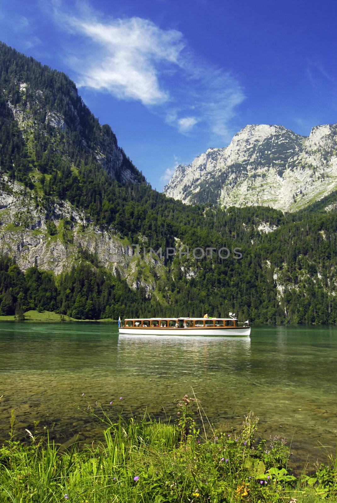 Sightseeing boat on the Kings lake in Germany with Alps in the back
