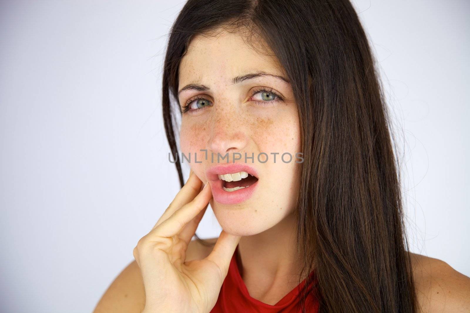 Gorgeous female model suffering bad toothache closeup