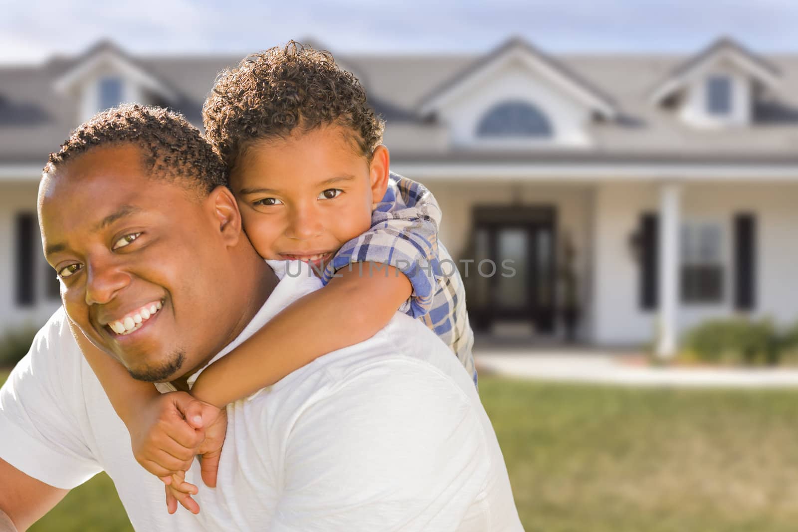 Mixed Race Father and Son In Front of House by Feverpitched