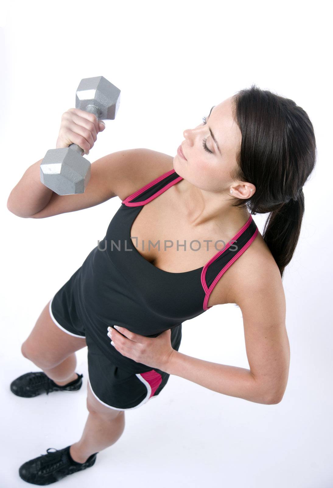 Sexy fitness instructor working out with free weights