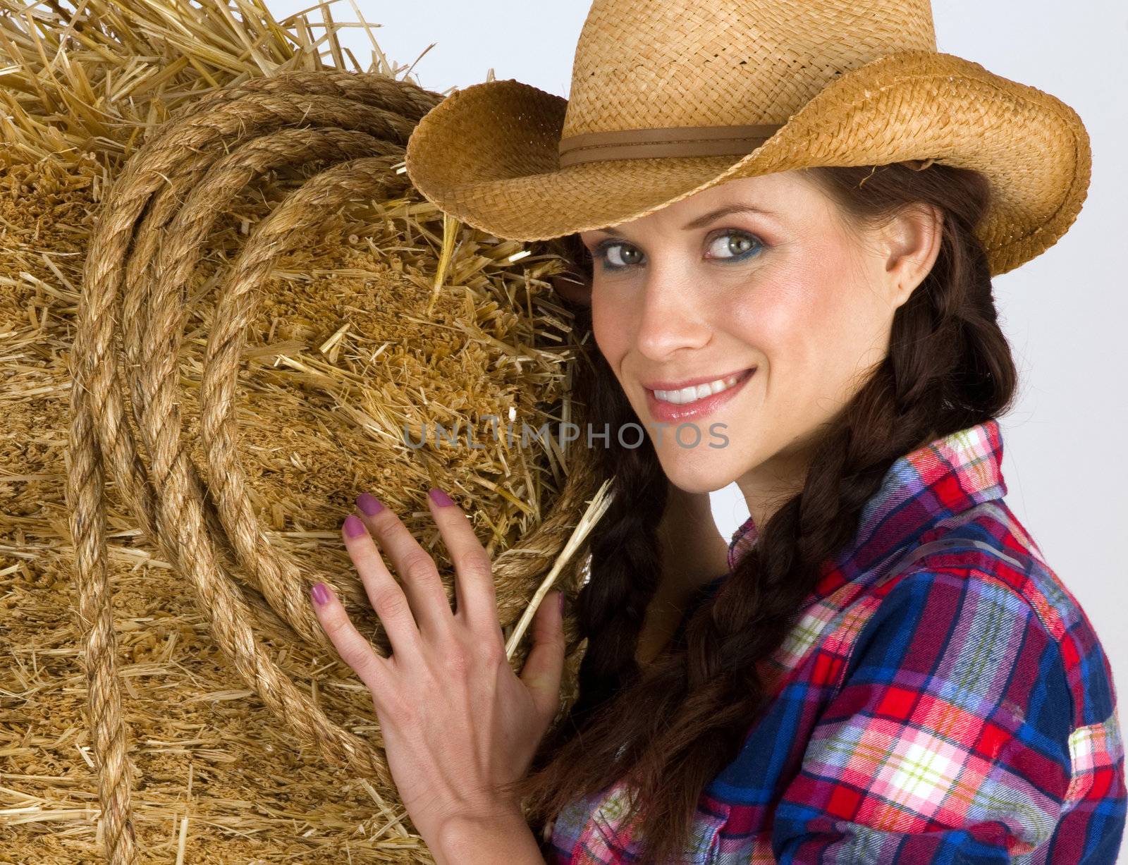 Portrait of a Western Woman by a bale of hay