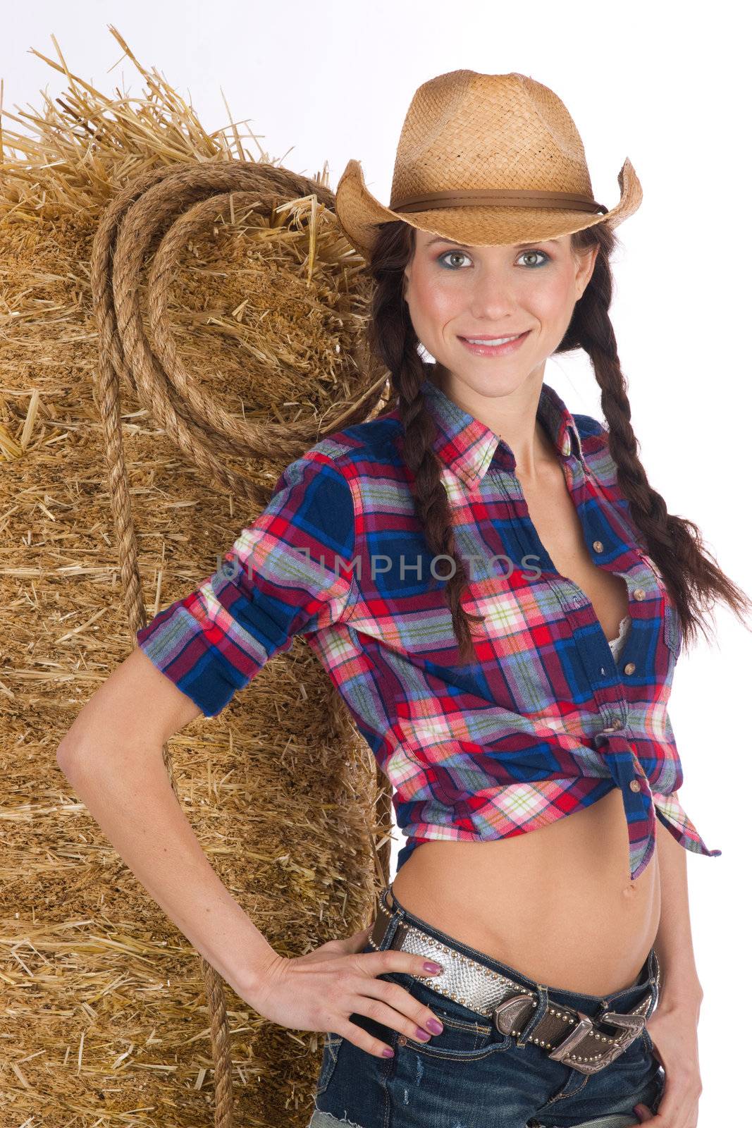 Girl from the West by a bale of hay