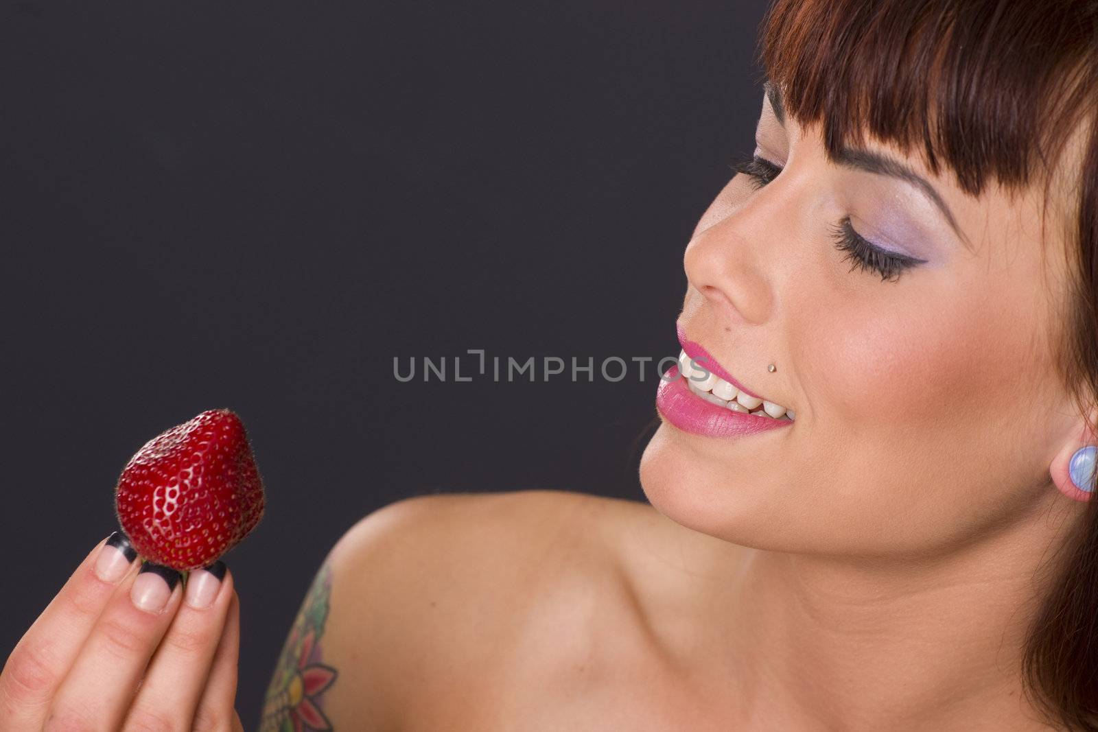 woman looks at her healthy snack of Strawberry