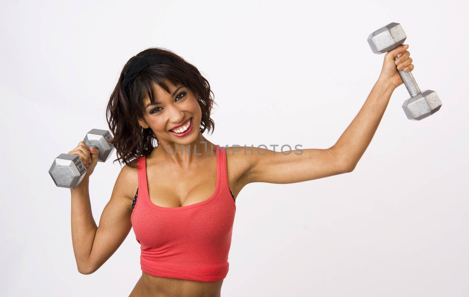 Pretty woman works out with barbells