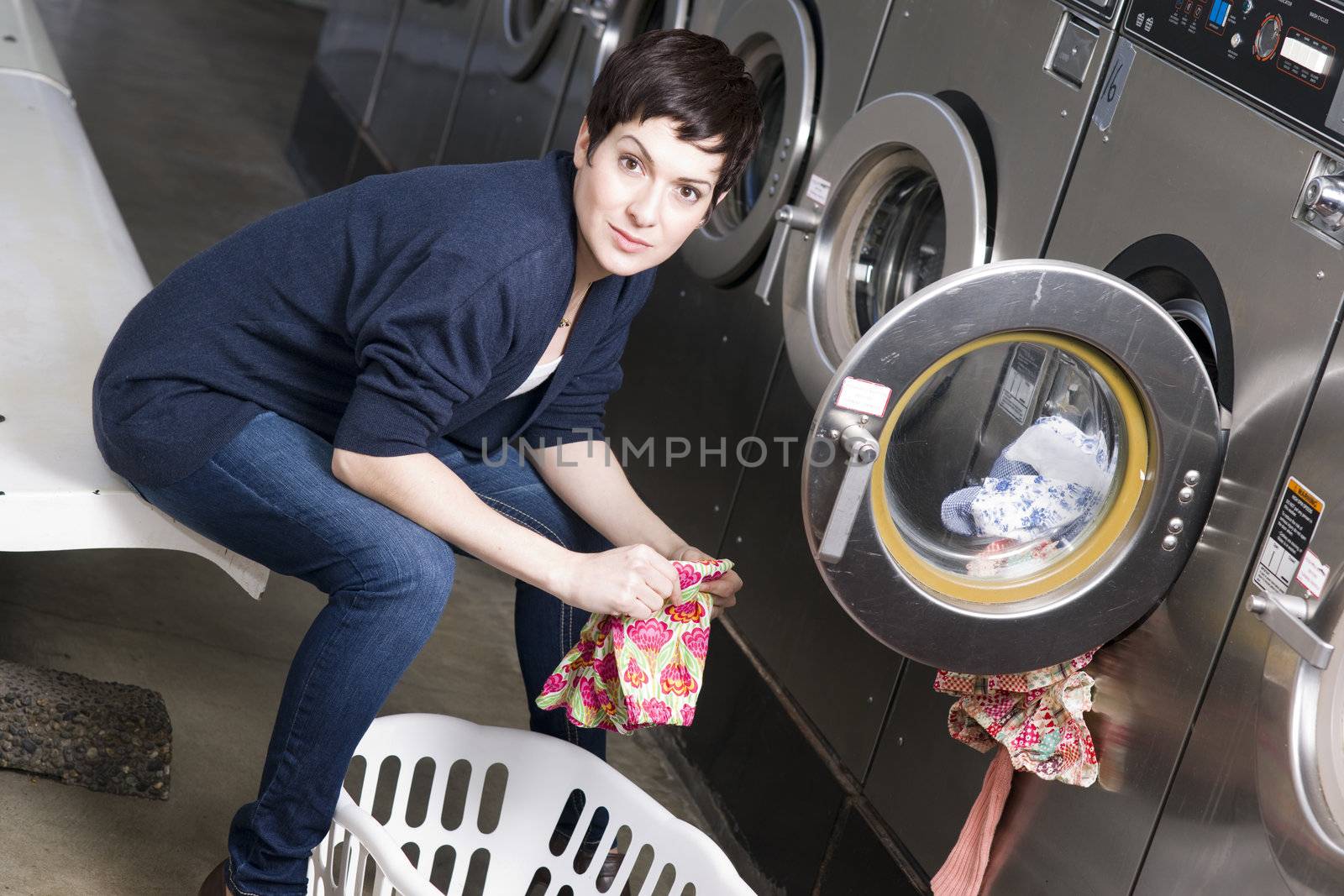 A woman toils at the laundromat