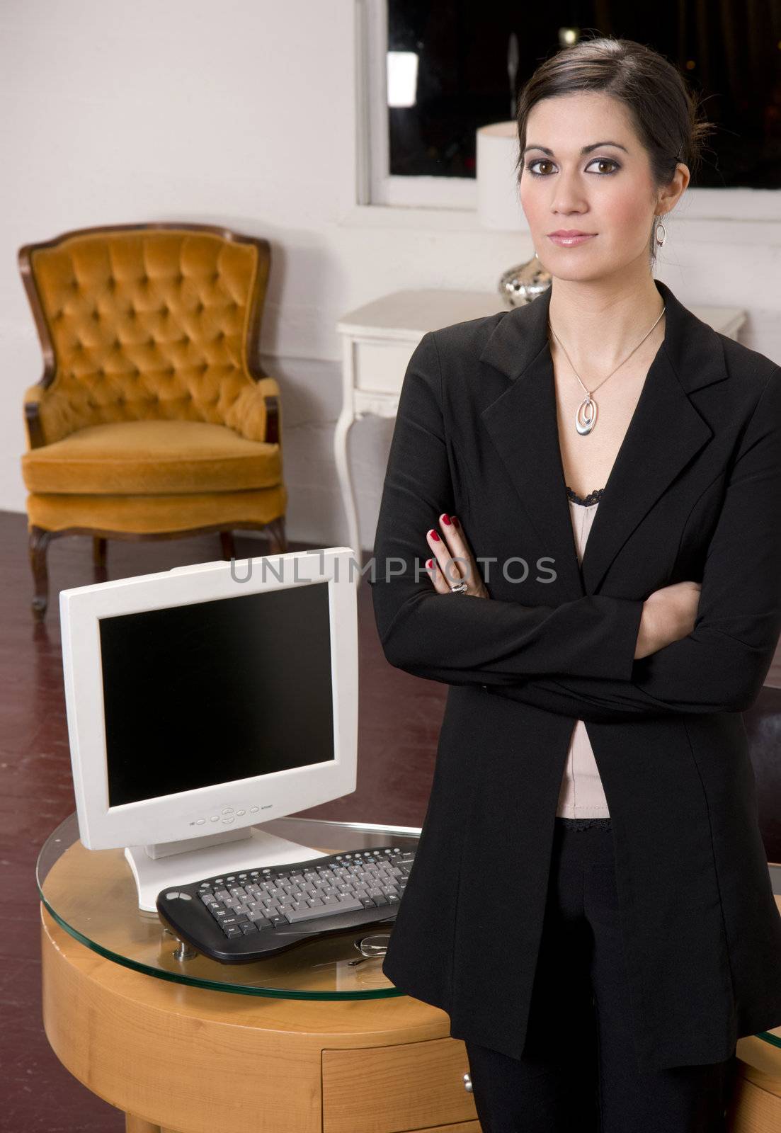 A Business Woman standing in front of her desk