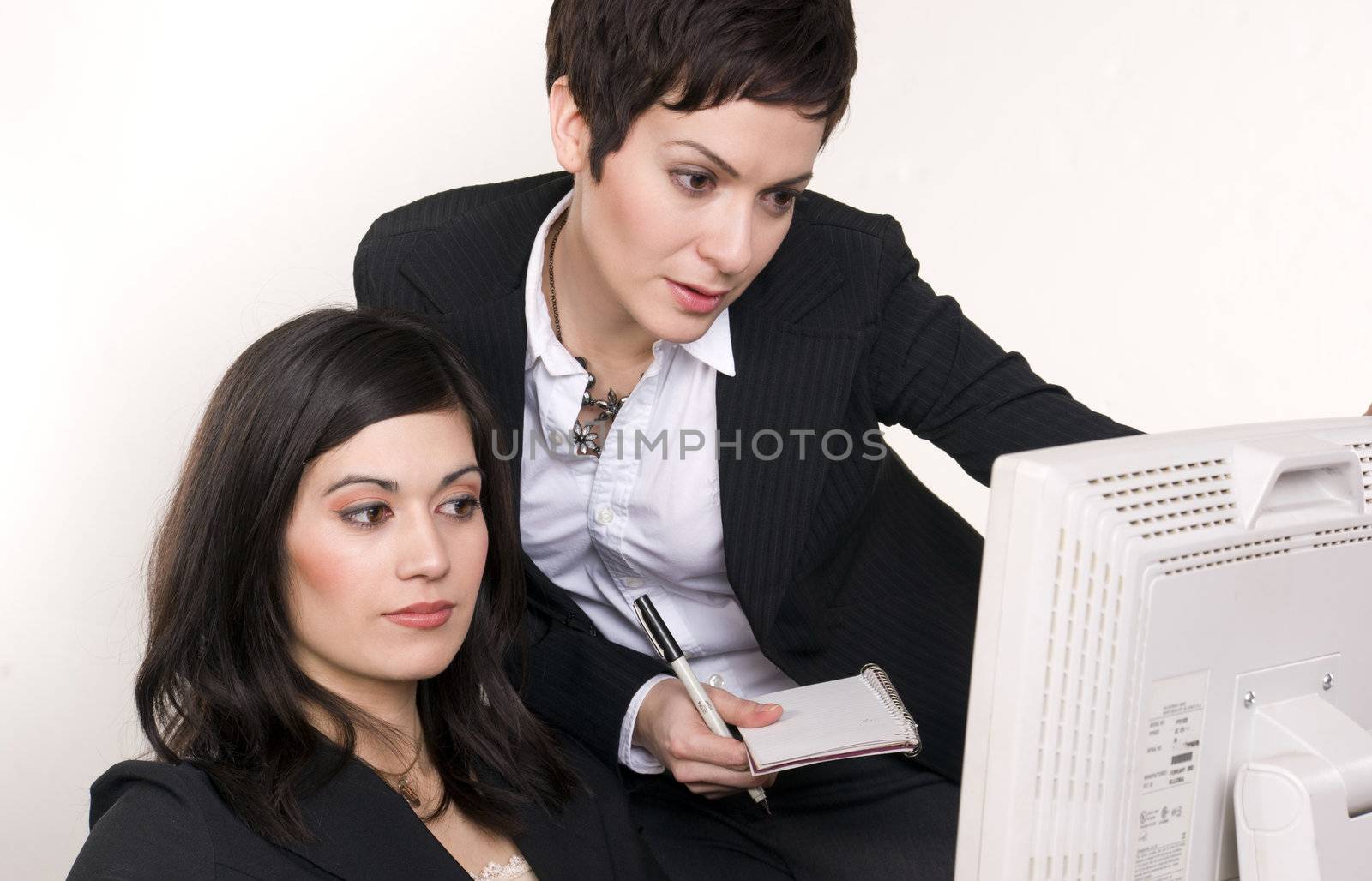 Two women collaborate at work
