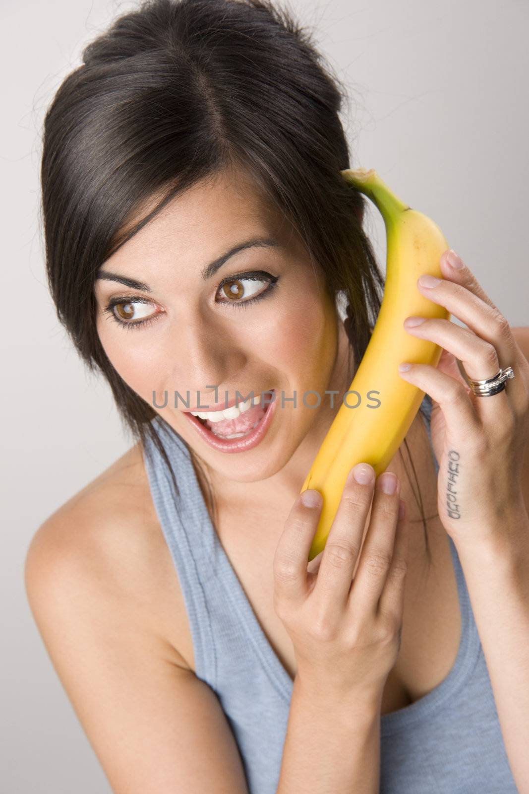 Beautiful Brunette holds a Banana