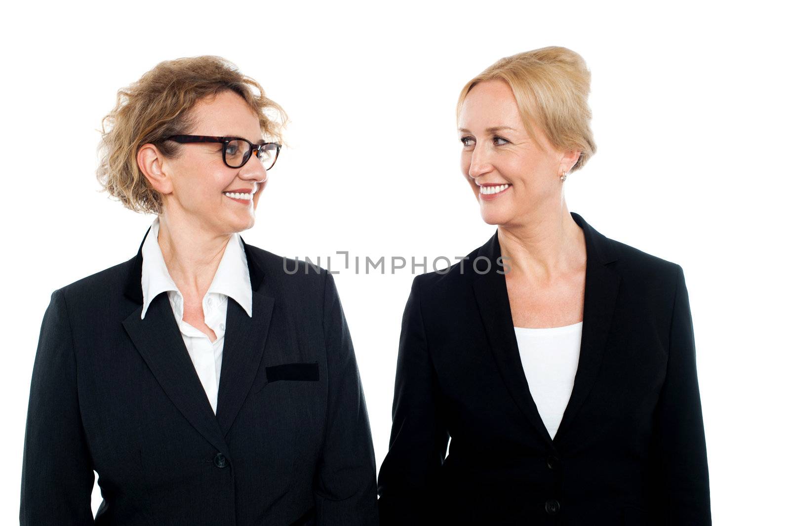 Aged corporate women looking at each other, business concept