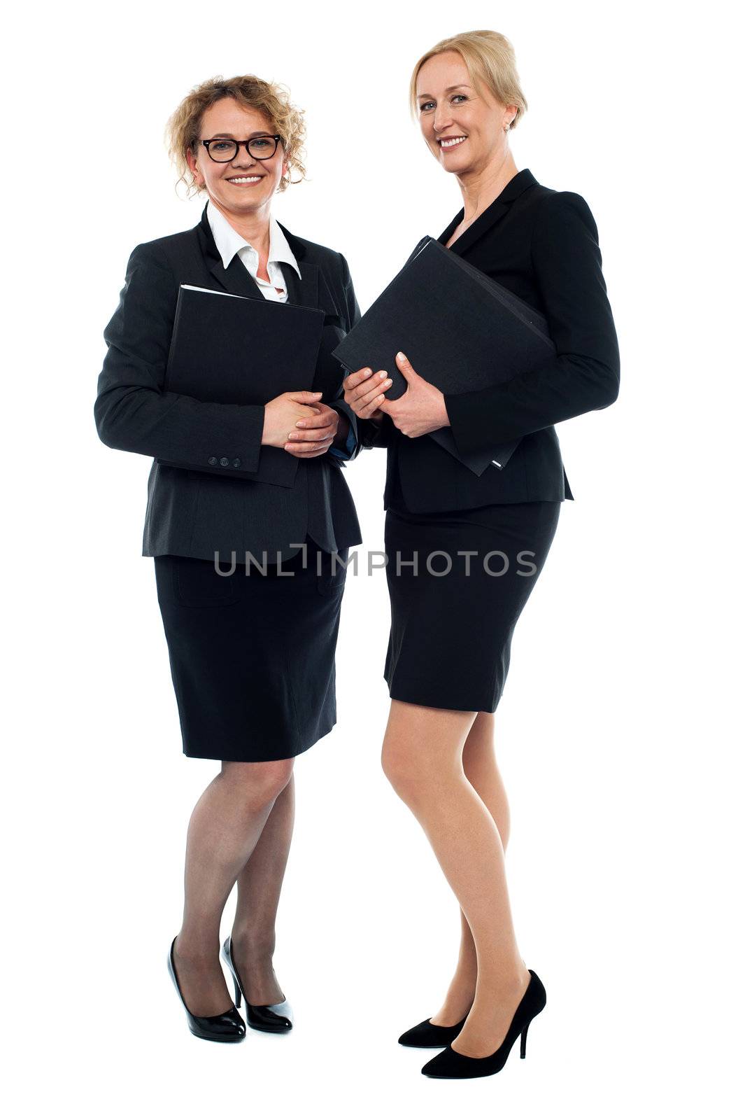 Aged businesswomen posing with documents,full length shot