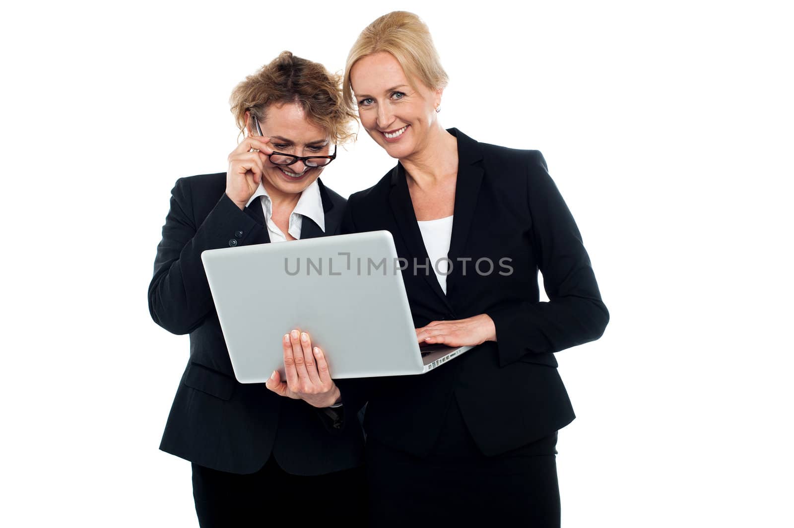Business friends enjoying video on laptop by stockyimages