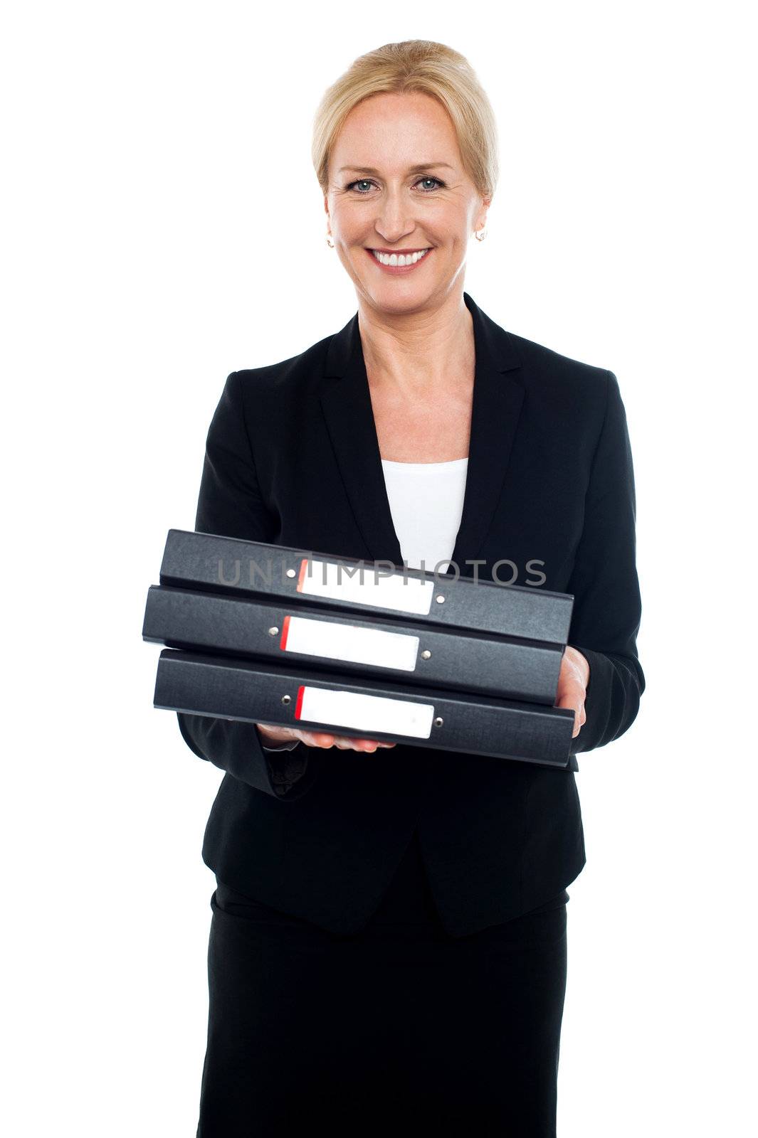 Cheerful female executive carrying business files, looking at camera