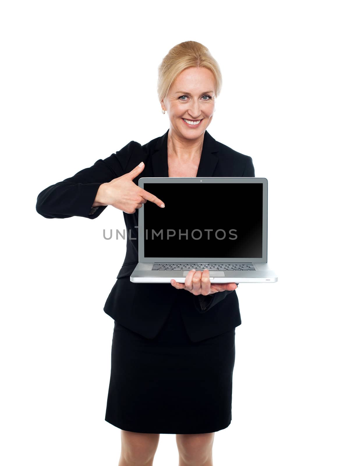 Smiling business lady indicating towards laptop screen isolated over white background