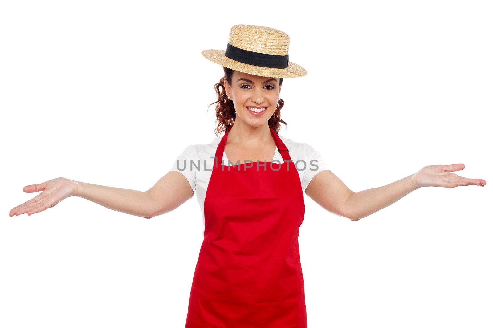 Pretty chef welcoming you with her arms stretched isolated over white background