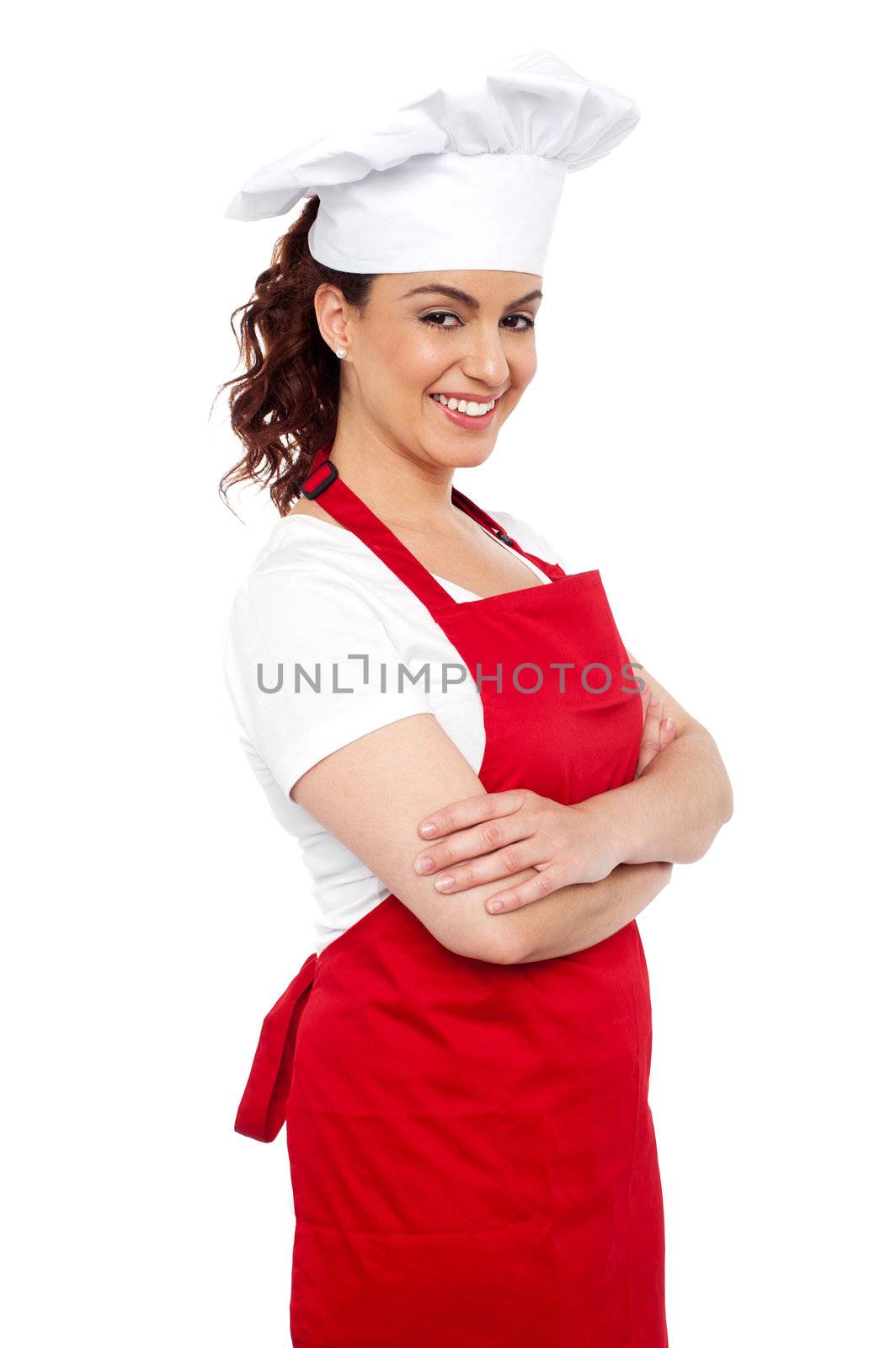Side view of cheerful chef posing casually with her arms crossed