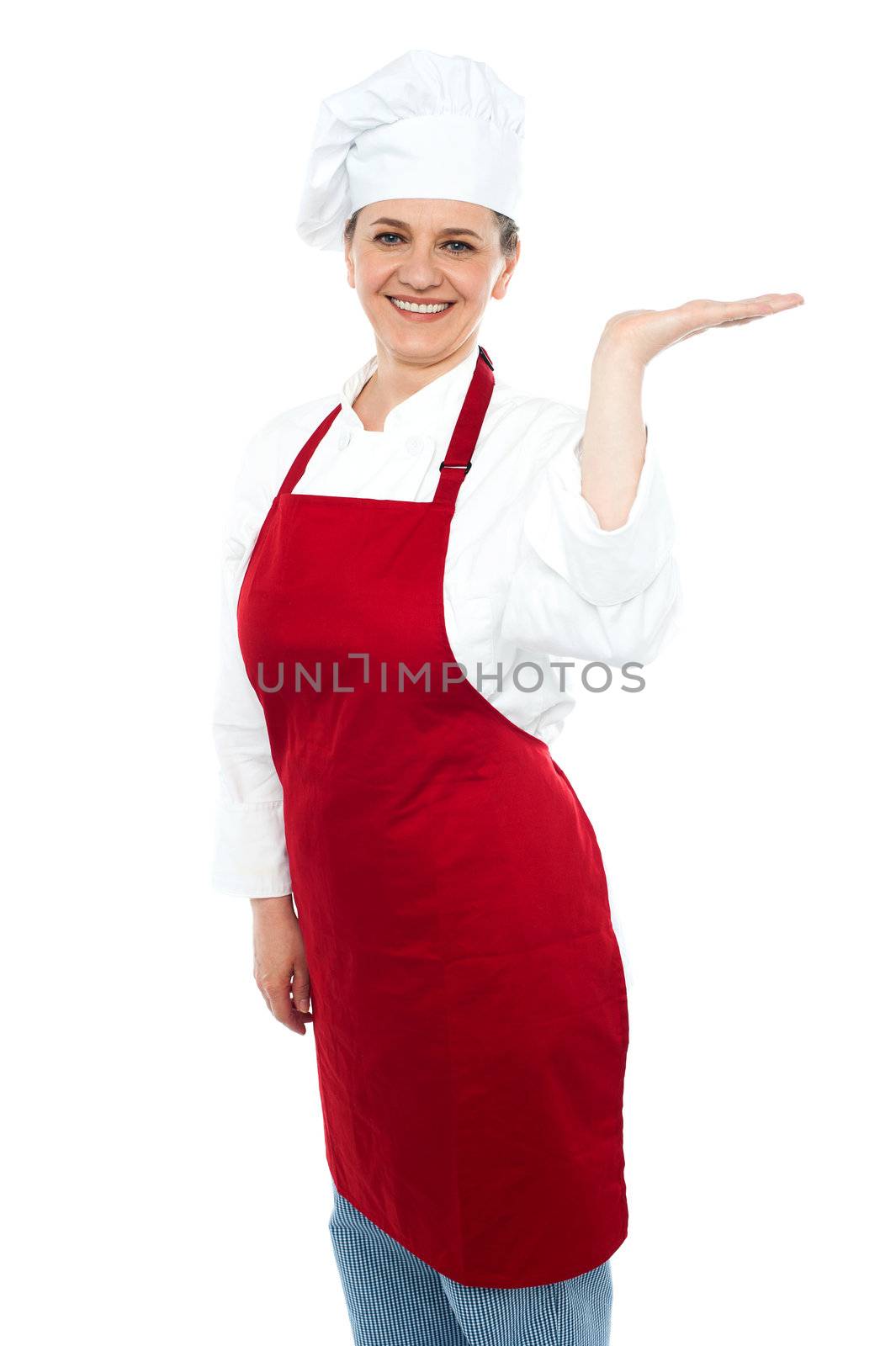 Smiling cook presenting copy space, open palm. All on white background