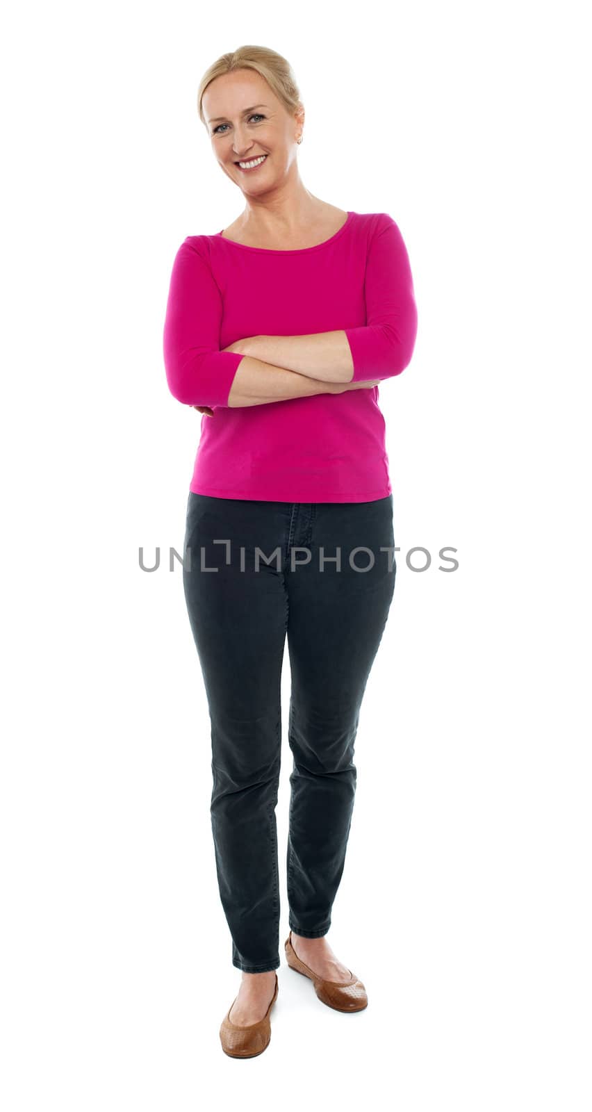 Full length portrait of happy aged woman posing with arms crossed isolated on white background