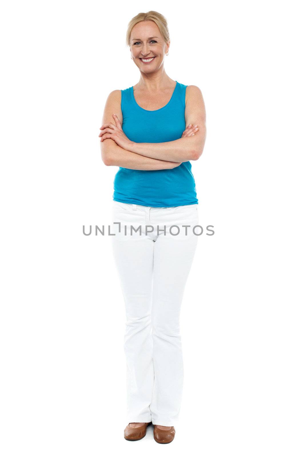 Full length portrait of casual cheerful woman posing with arms folded over white background