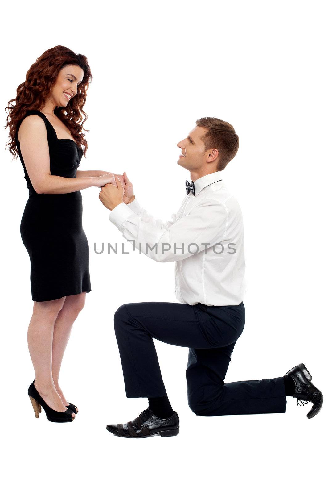 Handsome guy on knees proposing girl. Will you marry me?