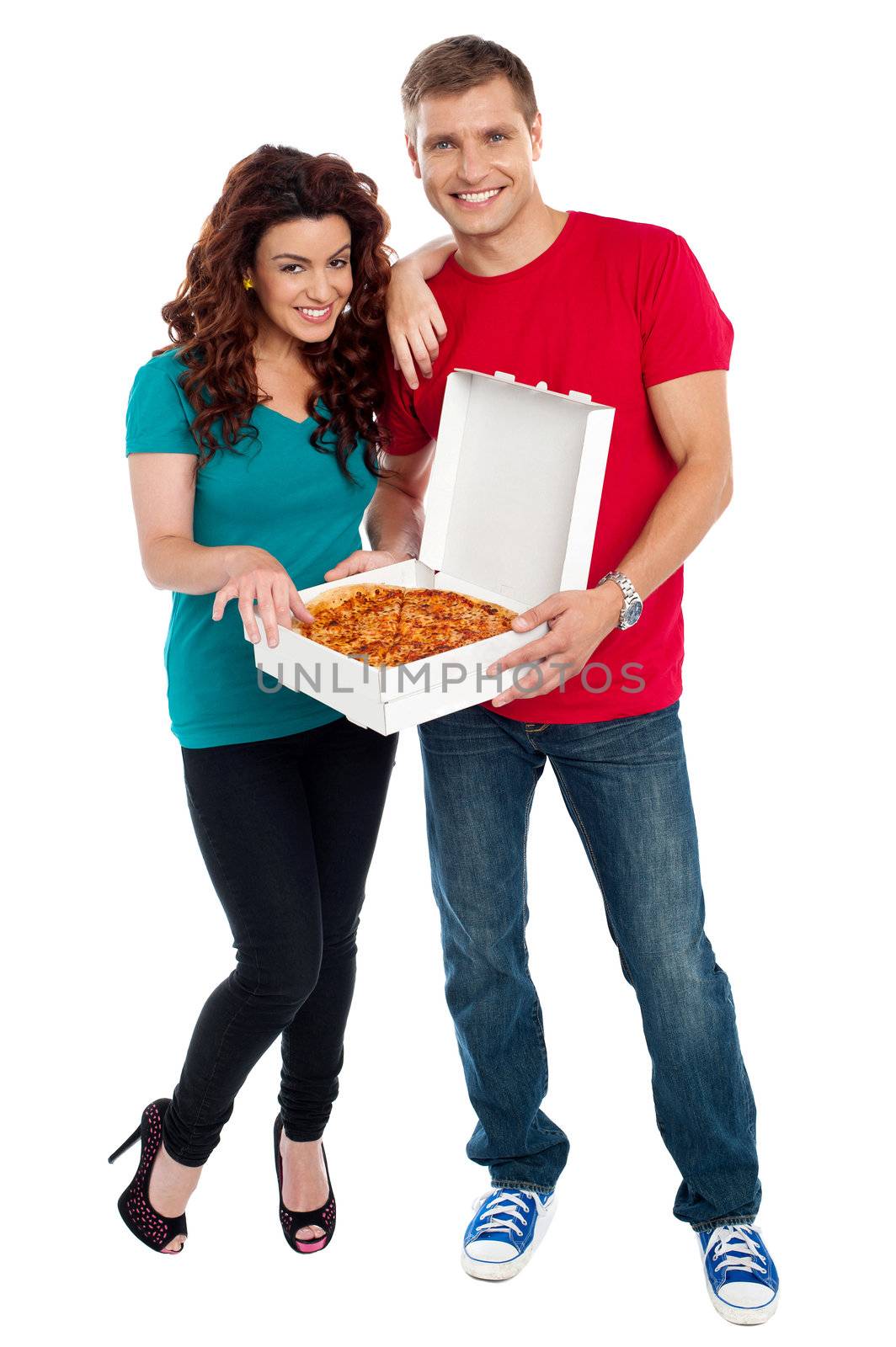 Young couple about to enjoy pizza together by stockyimages