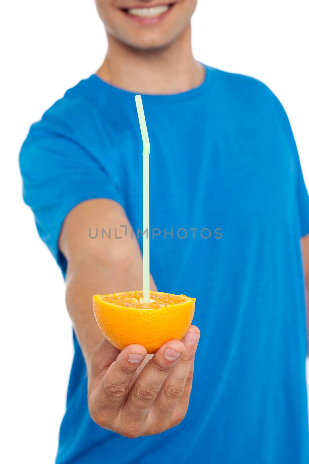 Cropped image of guy offering fresh orange with straw in it. Time to enjoy fresh juice