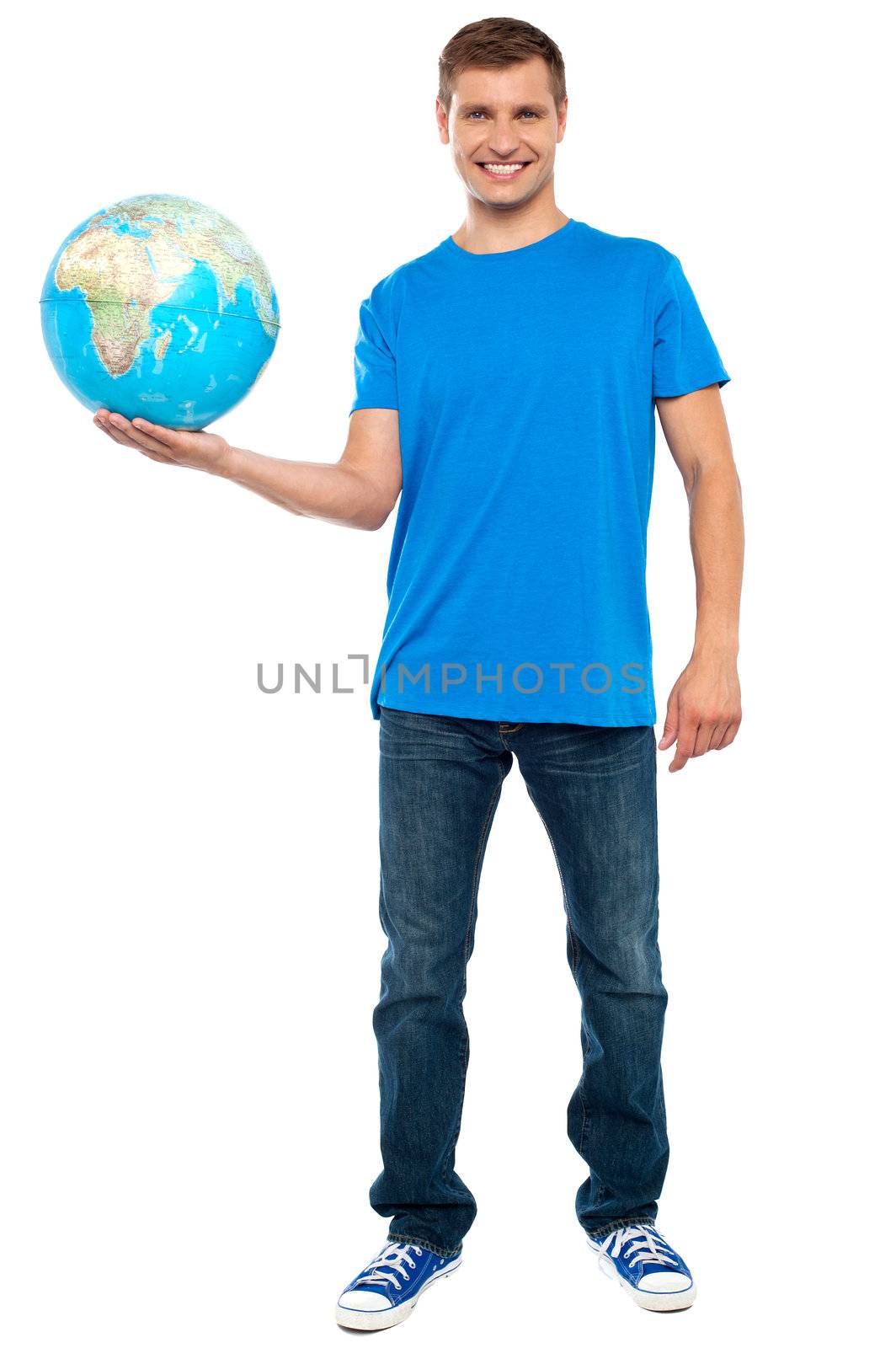 Trendy casual guy posing with a globe. Full length portrait
