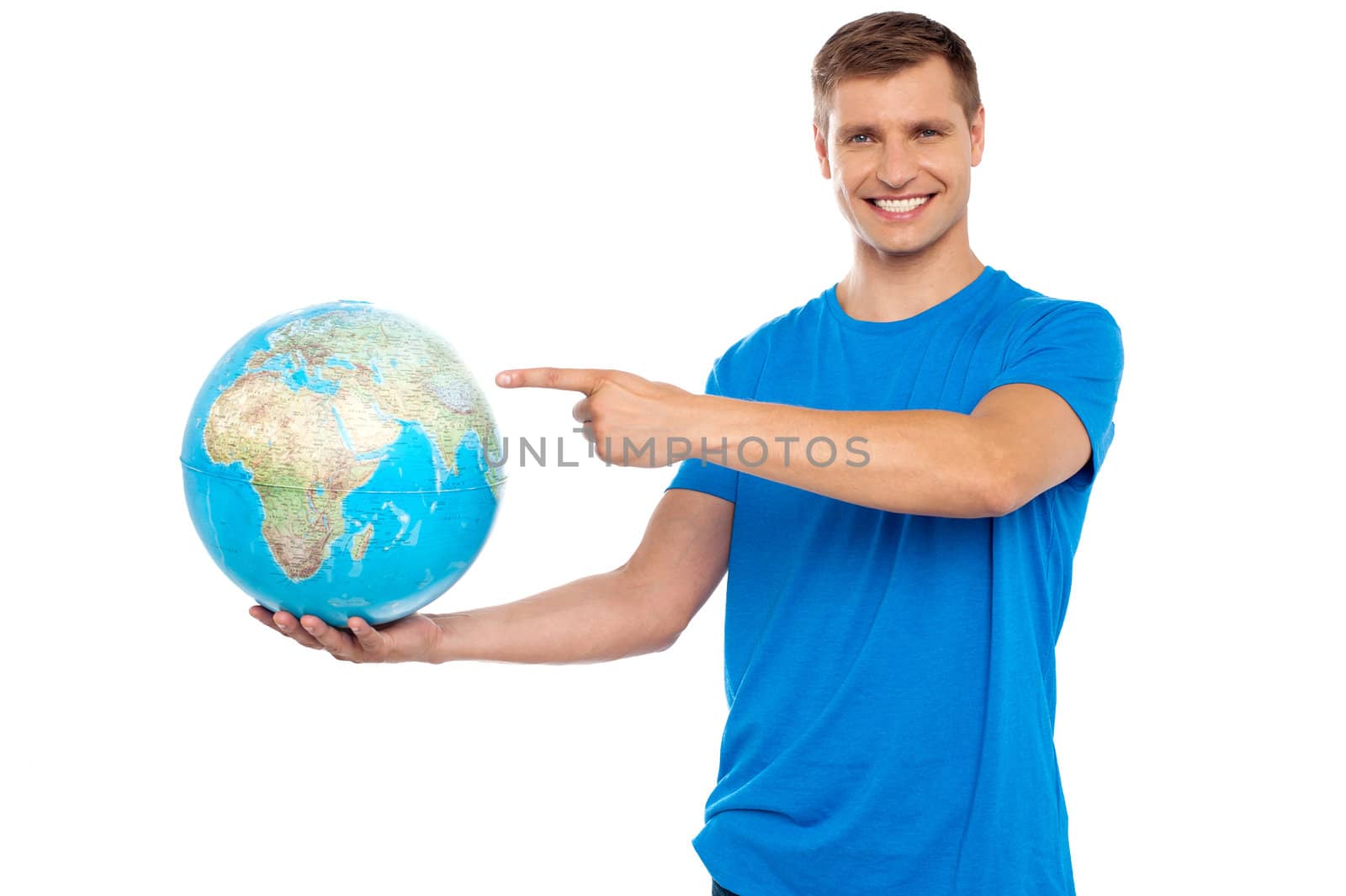 Handsome young smiling caucasian holding and pointing at the globe