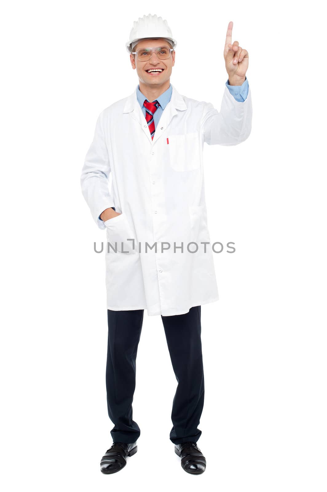 Young male architect pointing at copy space. Full length shot