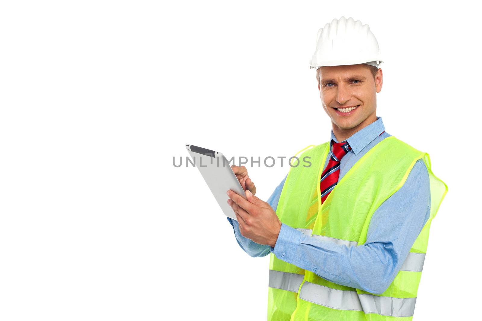 Construction engineer wearing safety hat and operating wireless device