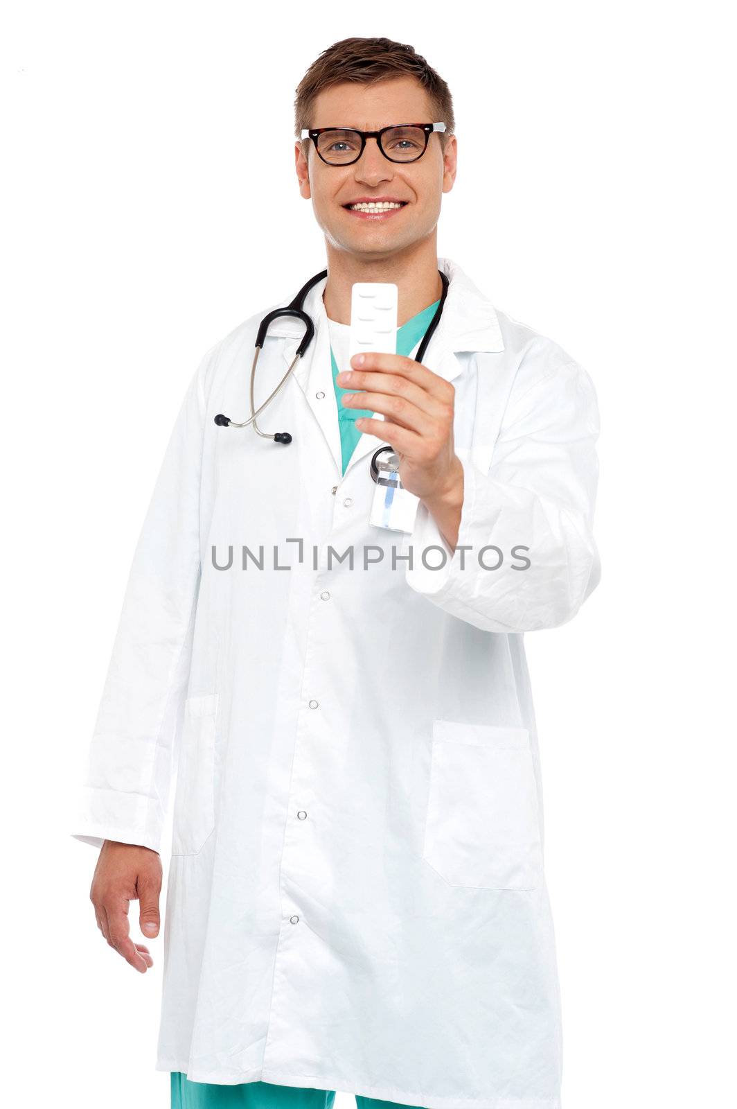 Smiling doctor showing tablets pack to camera isolated over white