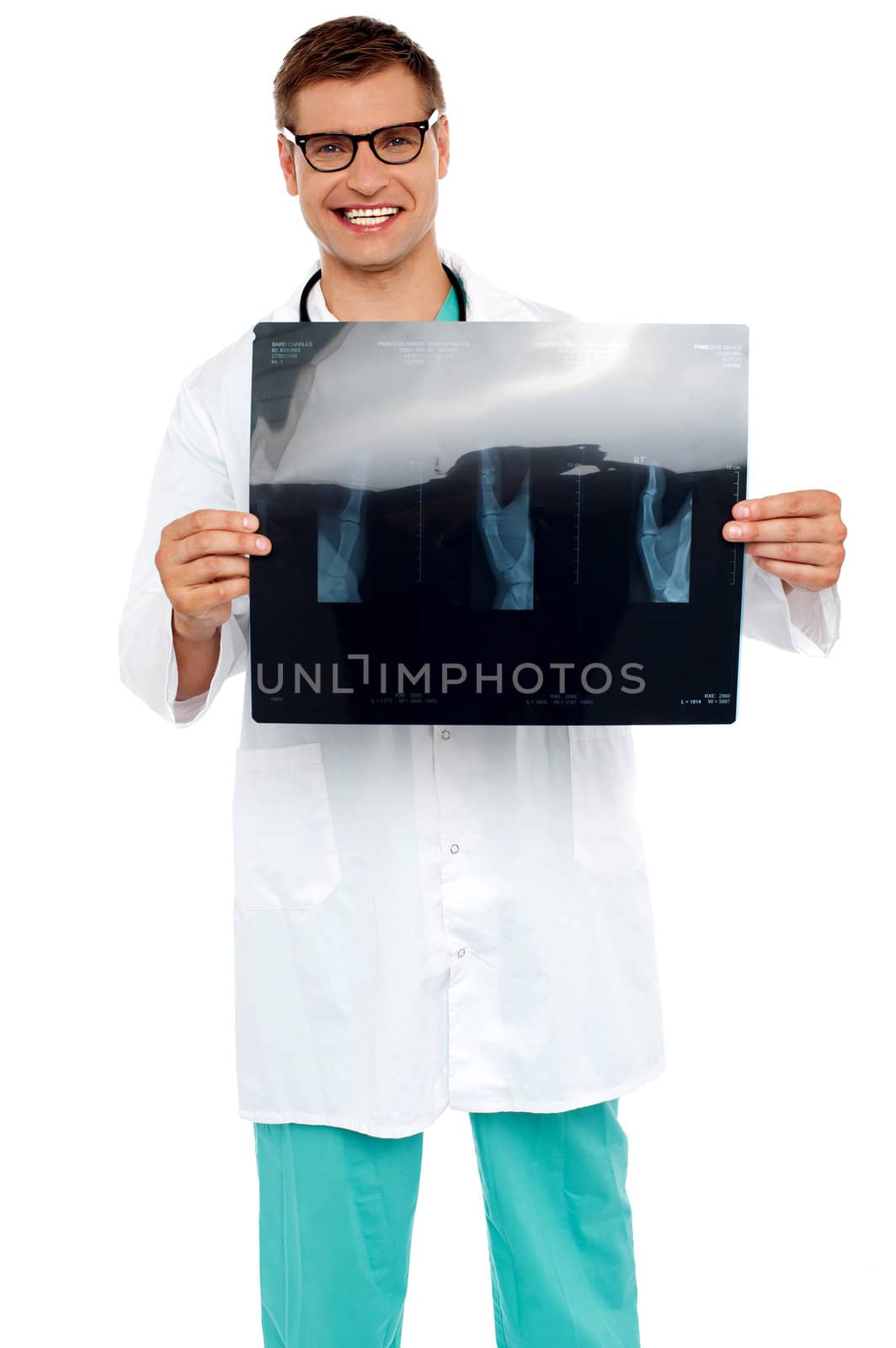 Happy young surgeon showing x-ray of a patient to camera. All on white background