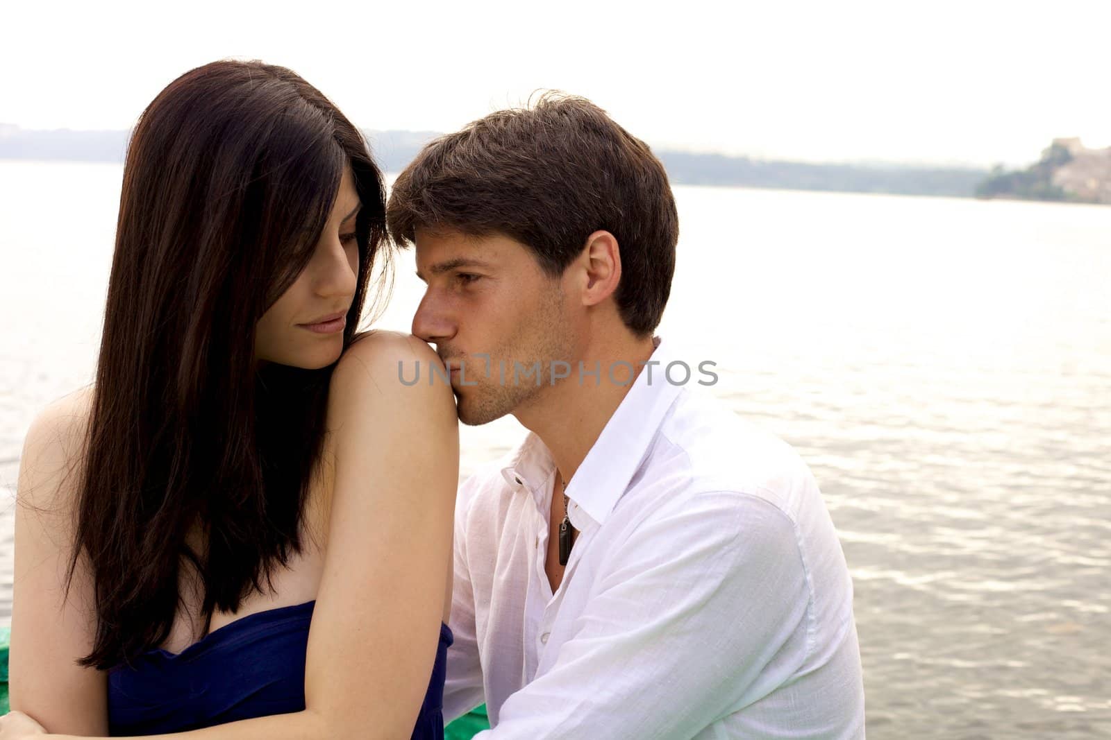 Couple romantic love moment during sunset on a lake 