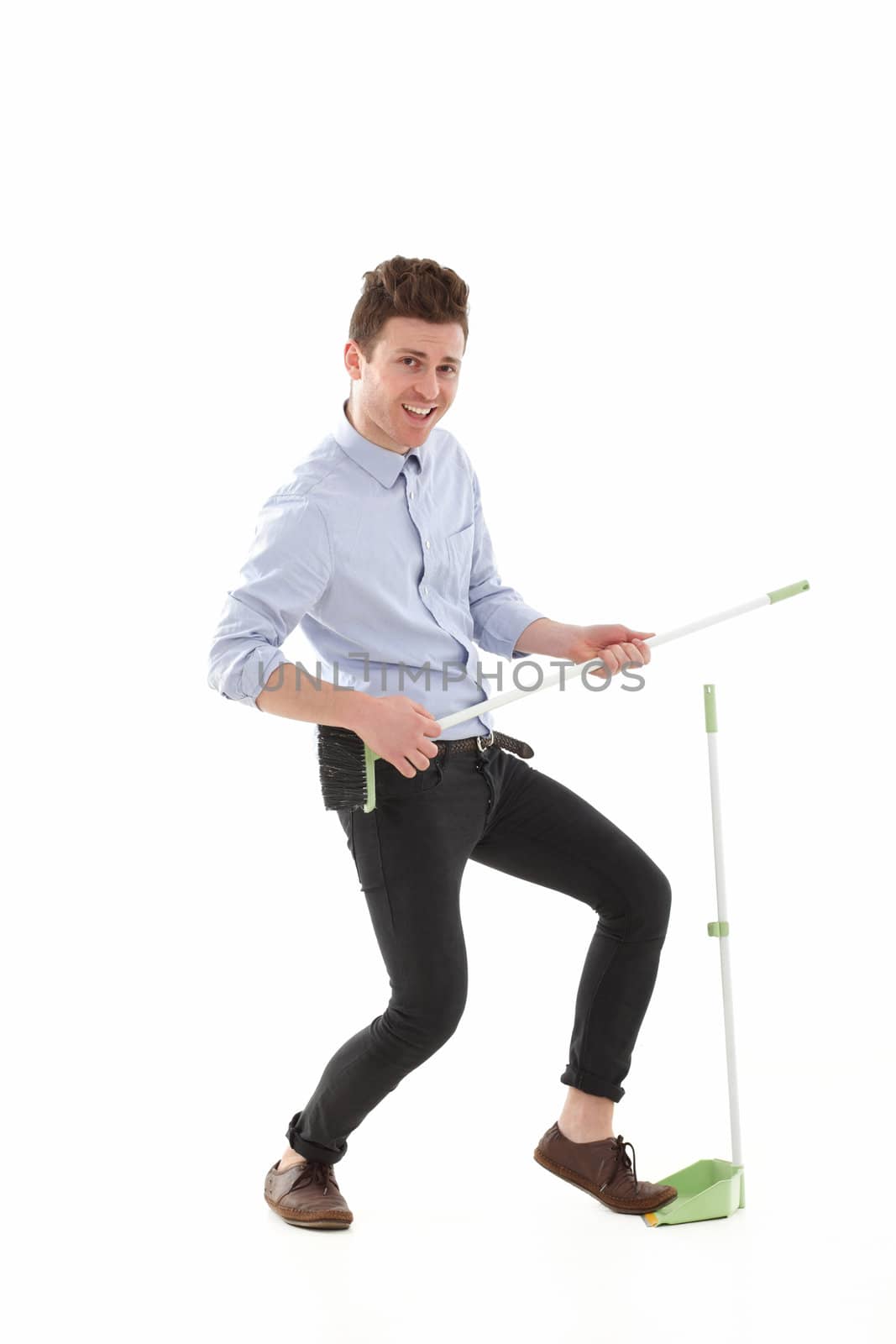 Adult young man singing while cleaning the floor