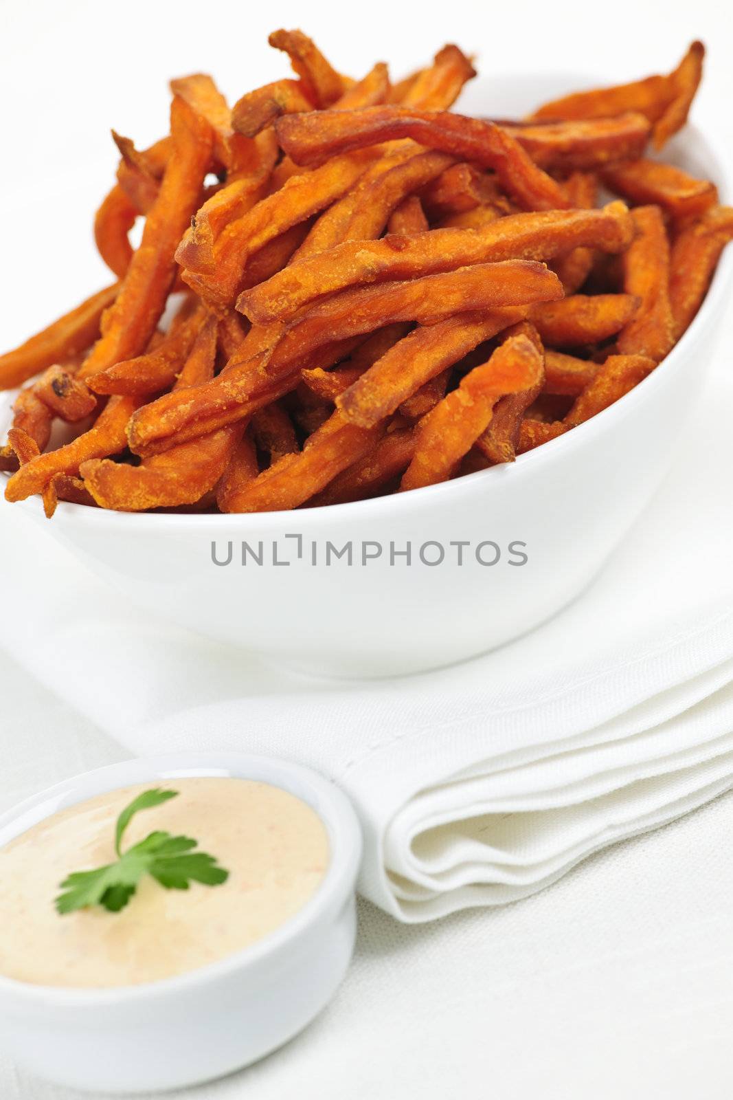 Bowl of sweet potato or yam fries with dipping sauce