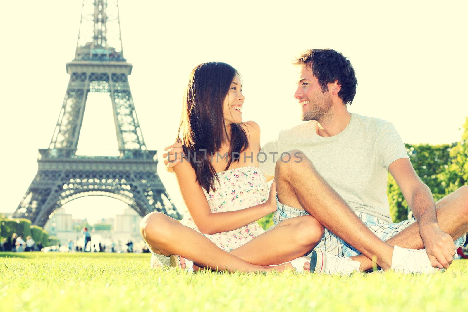 Travel tourists couple at Eiffel Tower Paris by Ariwasabi