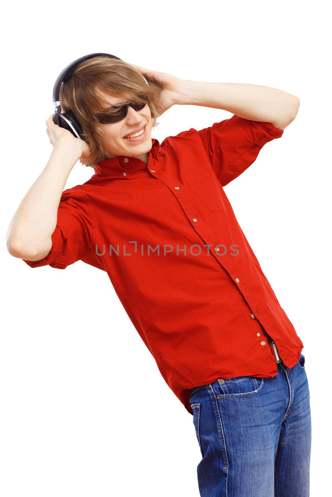 Happy smiling young man dancing and listening to music