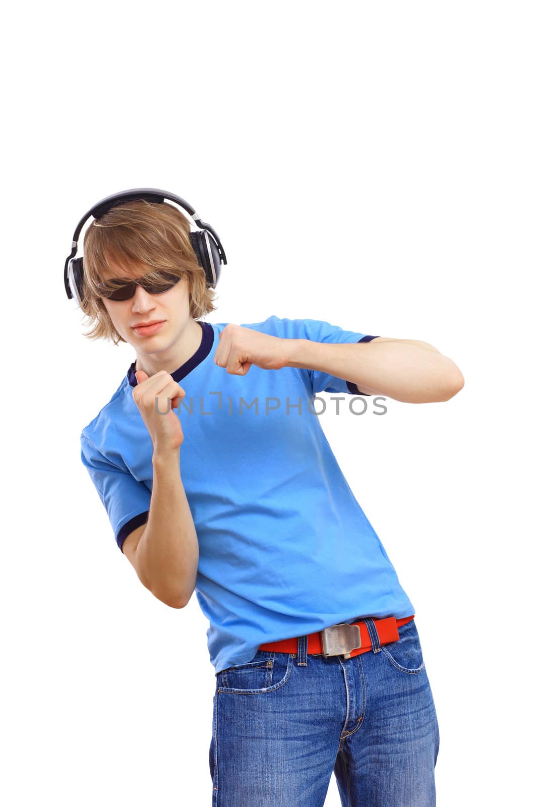 Happy smiling young man dancing and listening to music