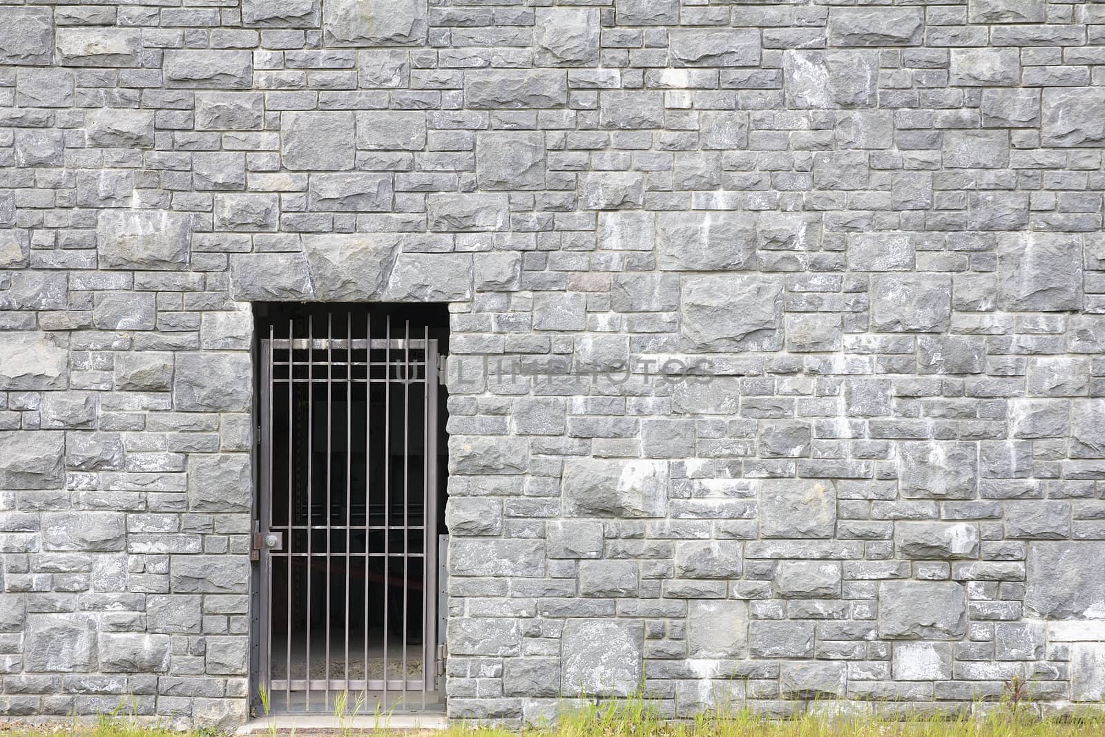 Metal Gate Entrance on Stone Rock Wall Background