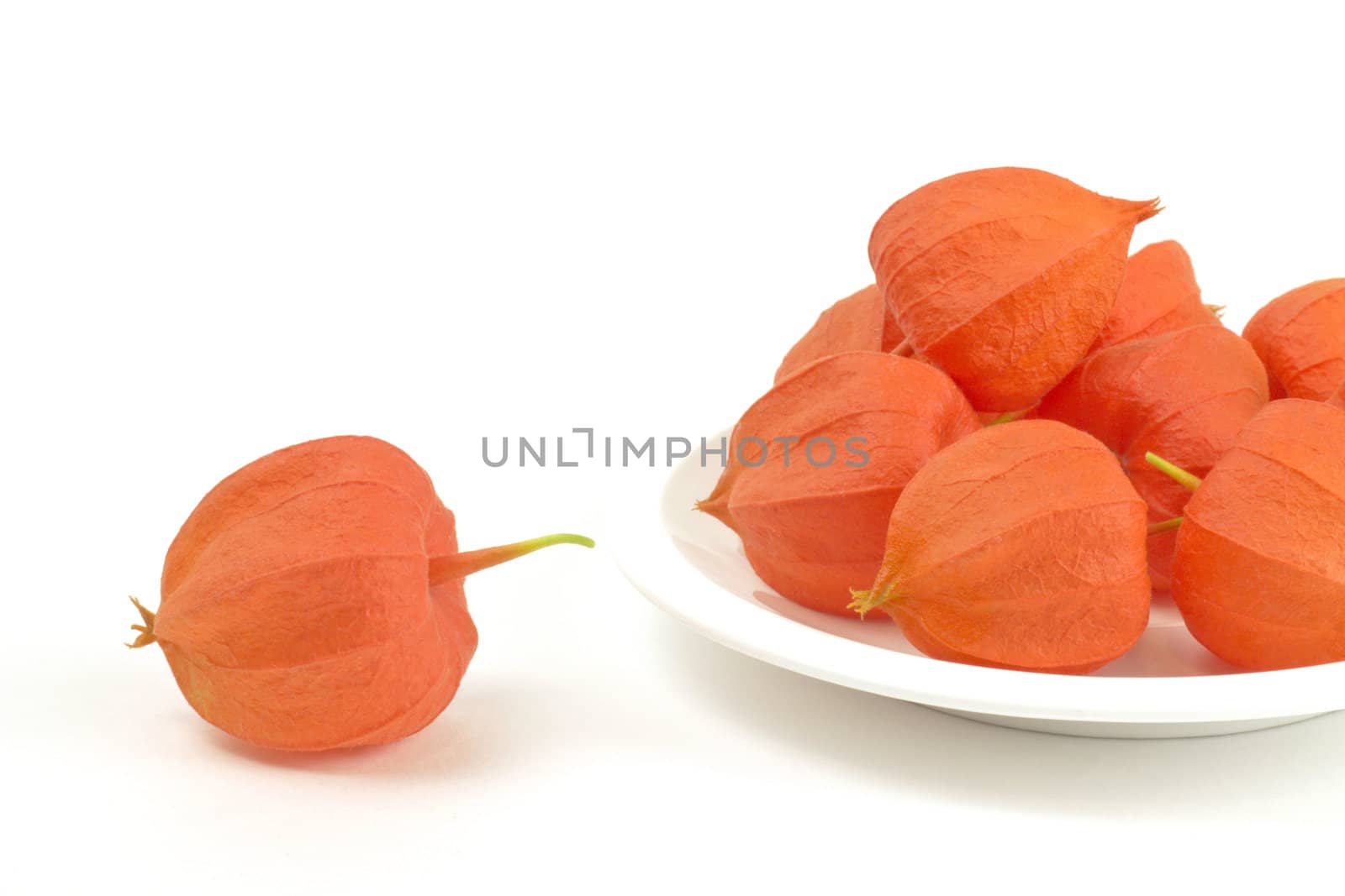 fine colored fruits on plate on white background 
