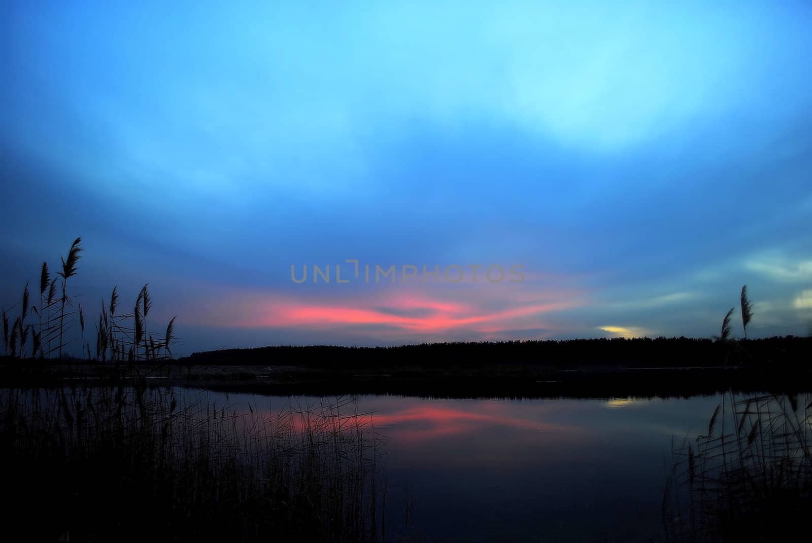 Polar lights over the lake in the late evening