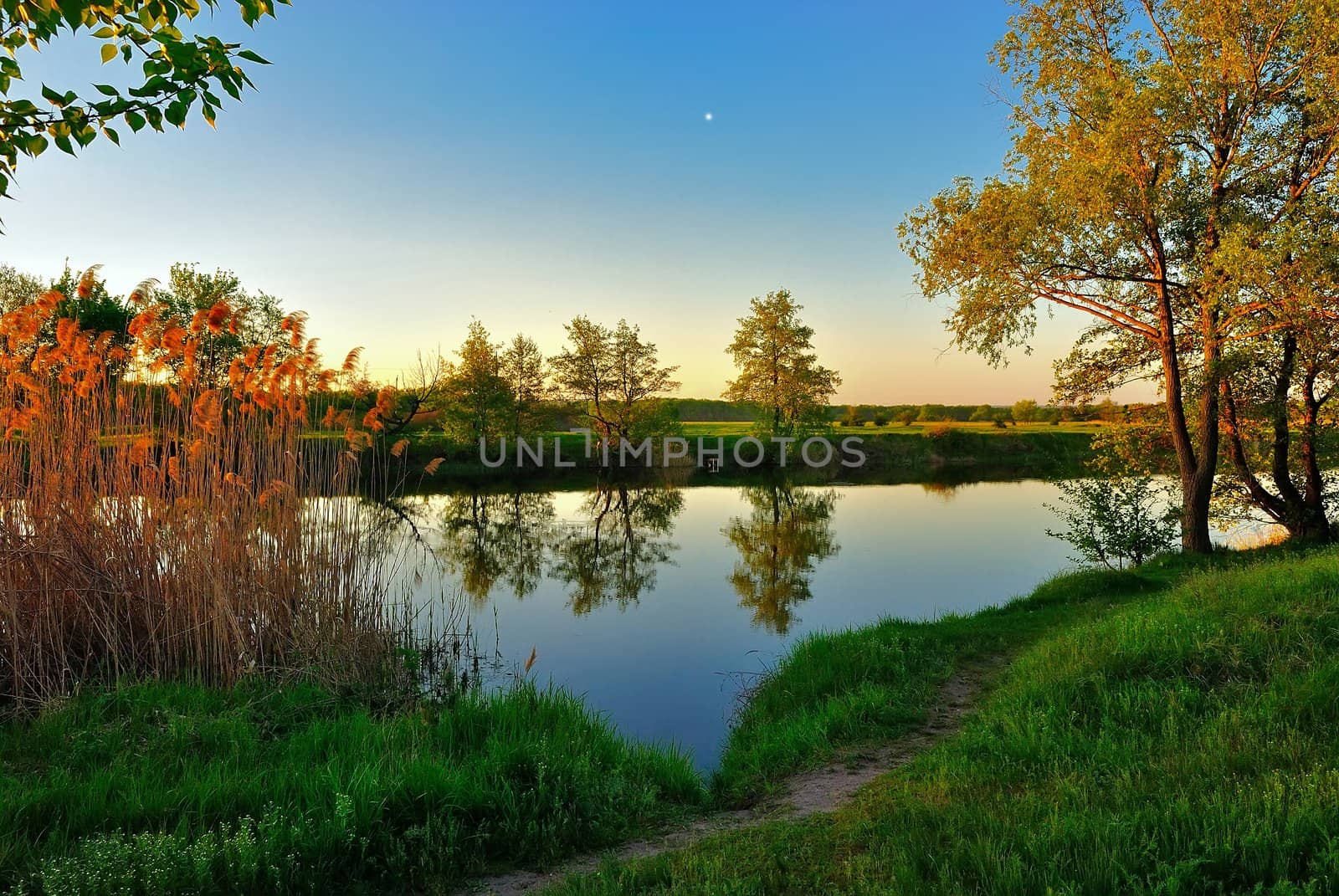 Star in the evening sky over the quiet river