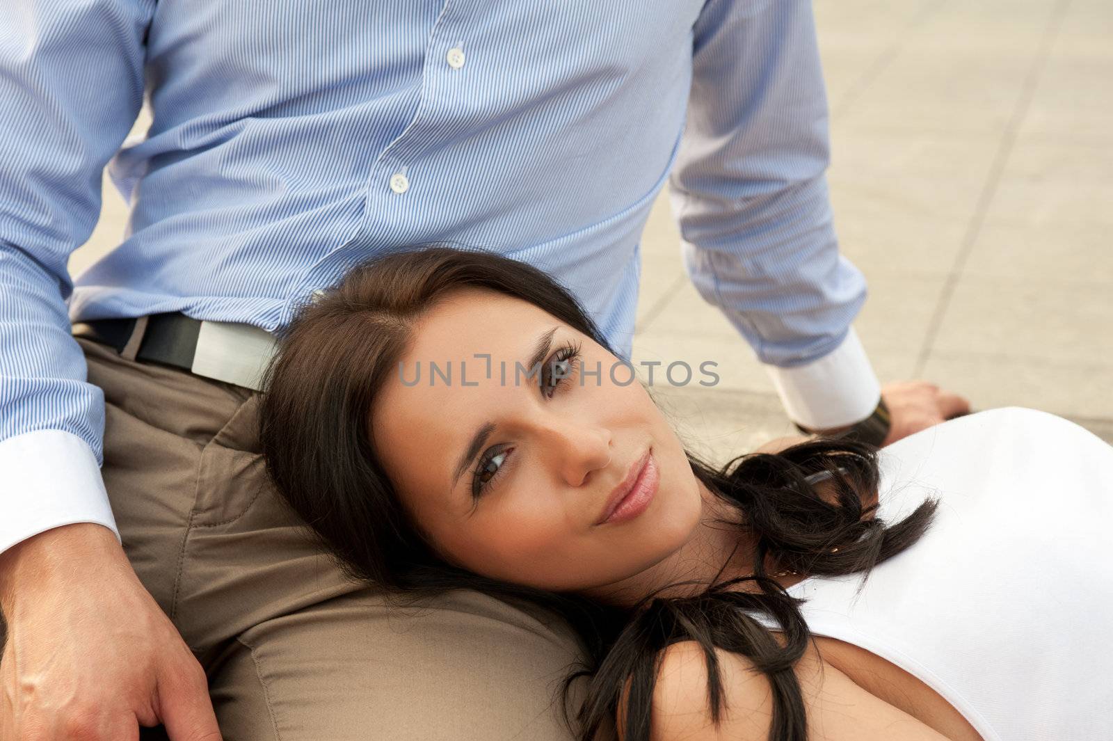 woman lying at mans knees at outdoor