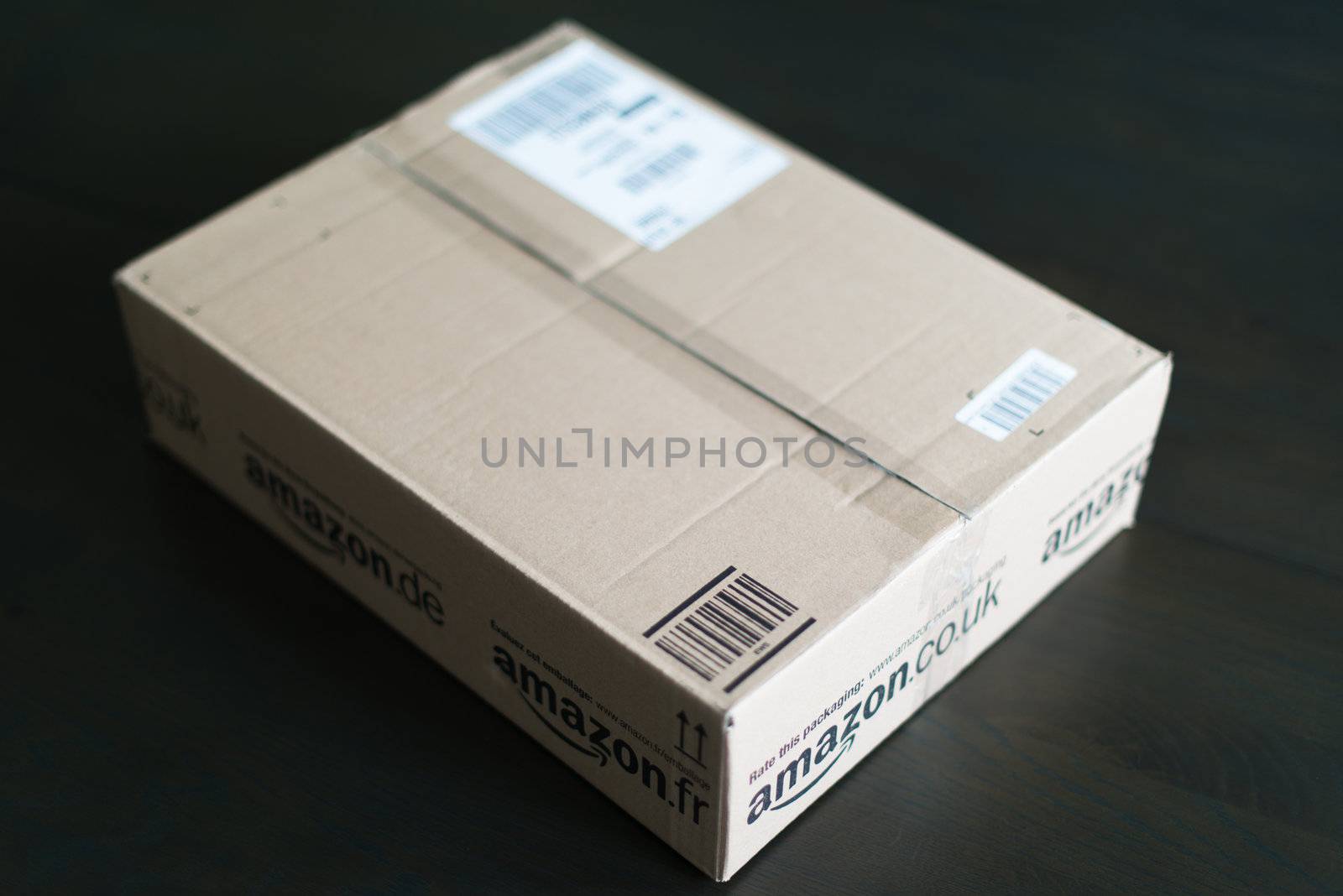 STUTTGART - SEPTEMBER 2: An Amazon.com parcel waiting on a table in a flat for being unpacked on September 2, 2012 in Stuttgart, Germany. Amazon.com is delivering thousands of parcels every day to German households.